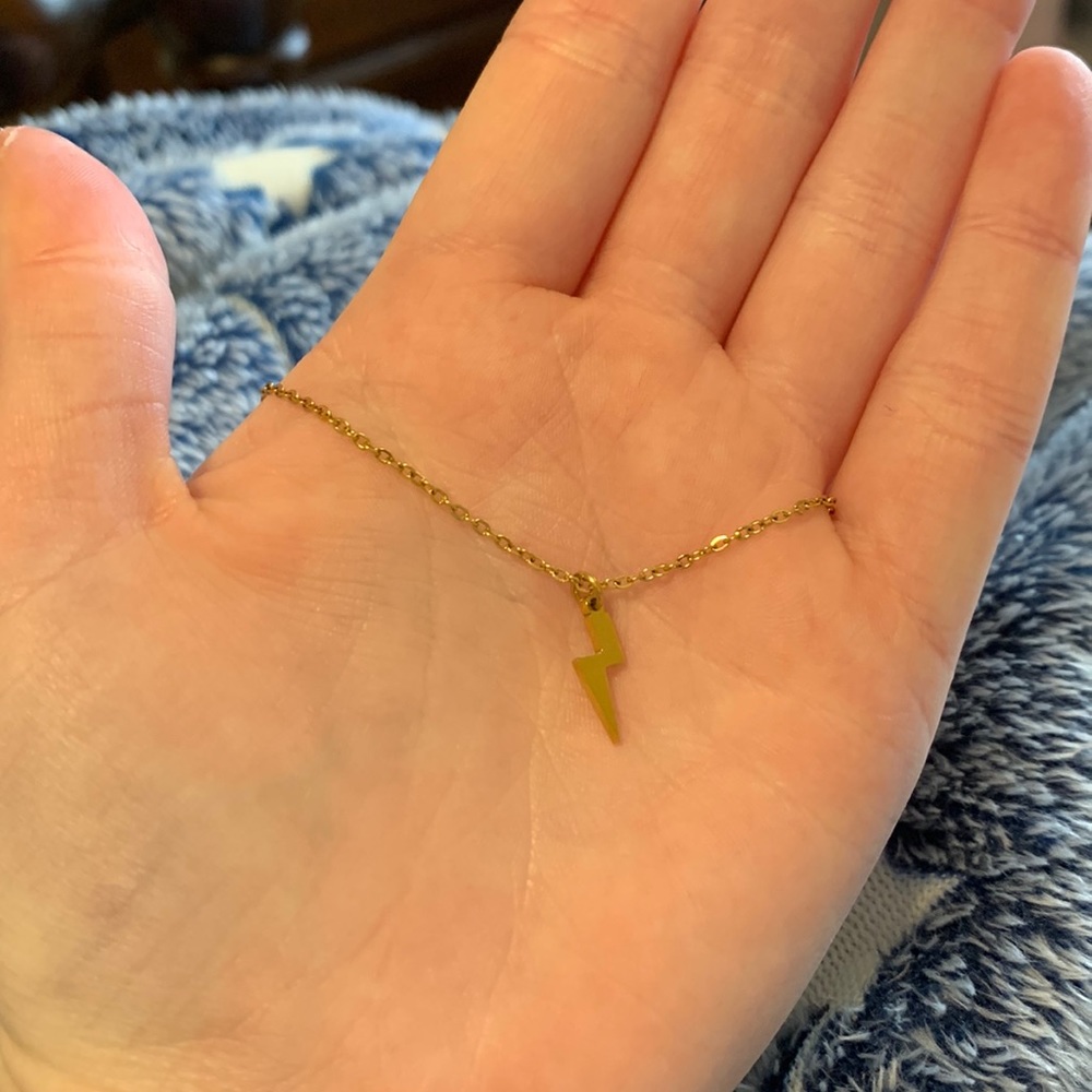 Adjustable gold bracelet with lightning bolt charm